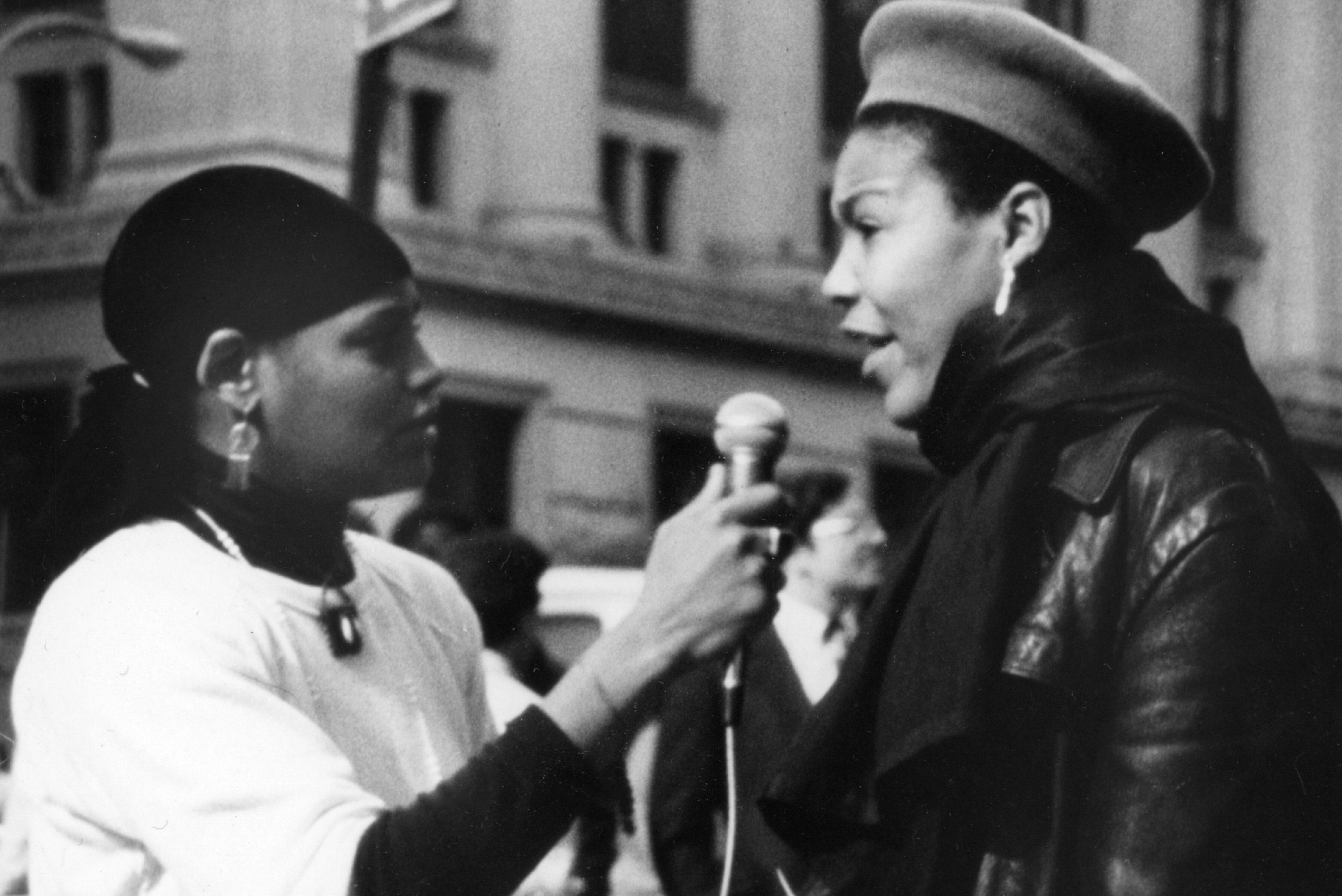 Black and white image of a woman interviewing another woman