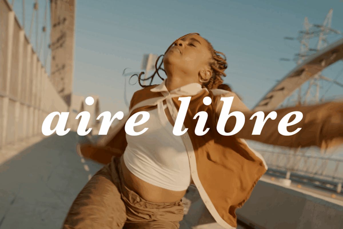 a woman dances across a bridge, her movements strong