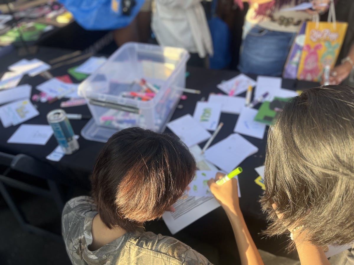 Students draw on postcards