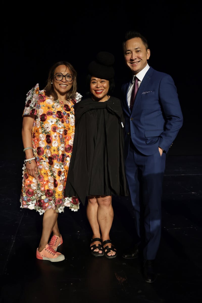 Celine Parrenas Shimizu, Rhacel Salazar Parreñas and Viet Thanh Nguyen pose together on a darkened stage