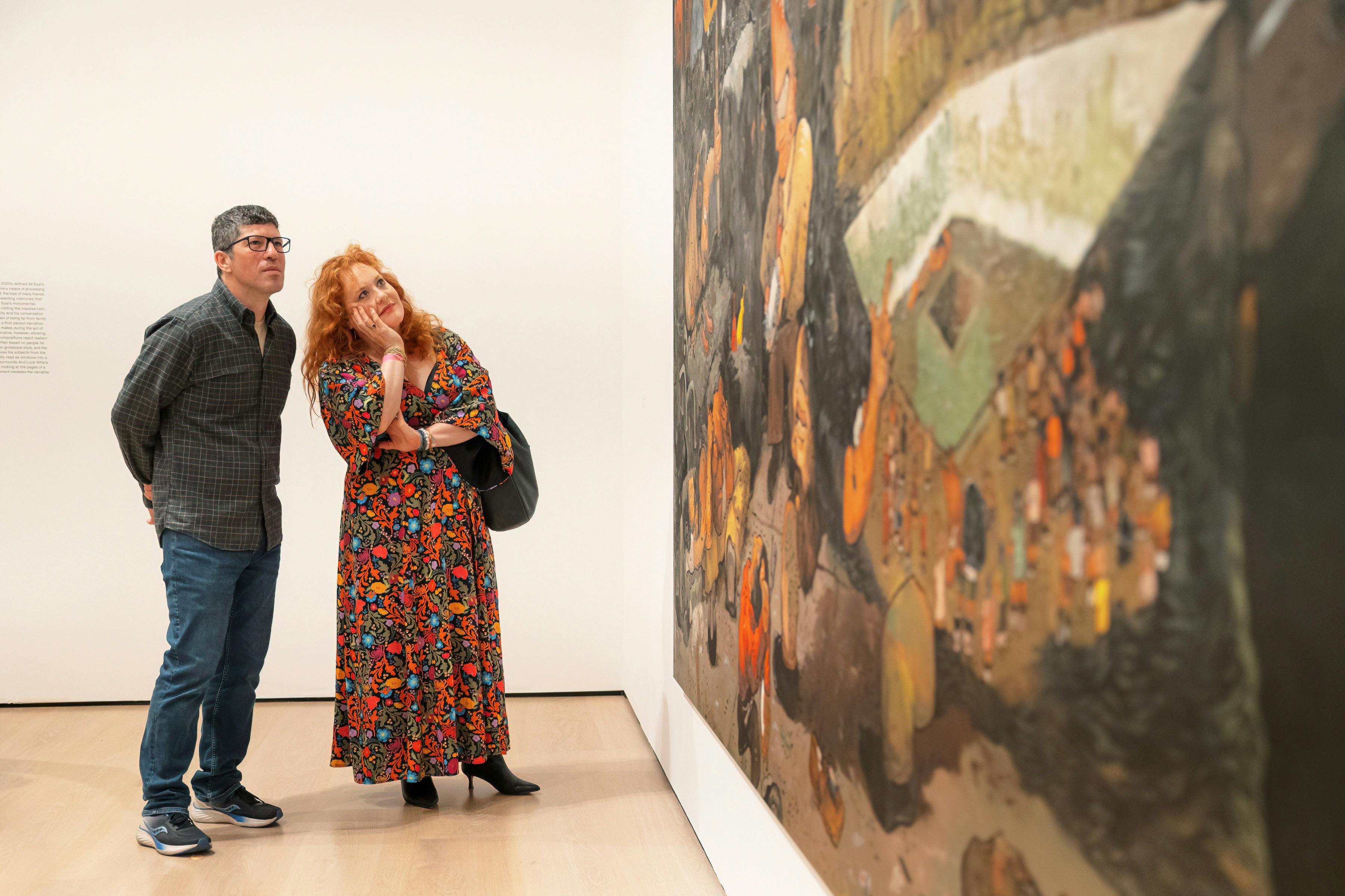 People in the hammer museum gallery take a close look at Ali Eyal's piece titled "and look where I went"