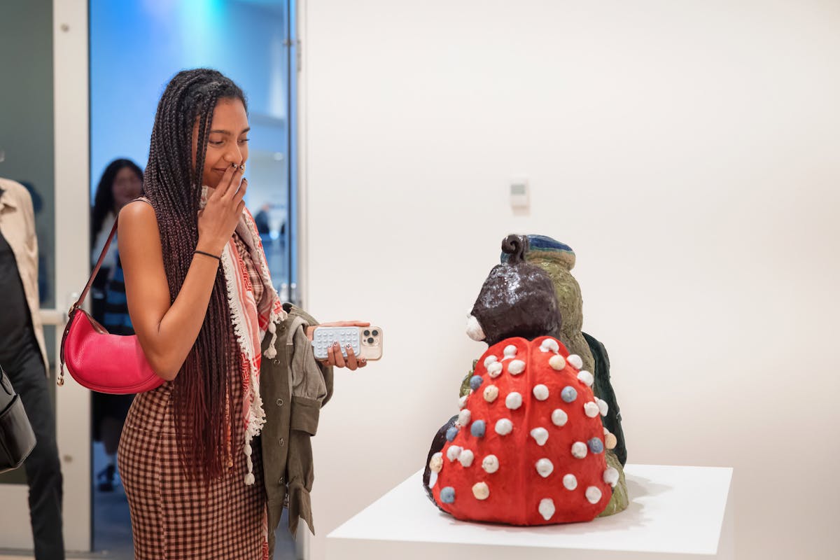 A museum attendee at the Hammer views ceramic work by Alake Shilling