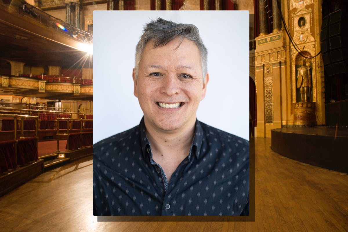 Headshot of Sean Metzger against a backdrop image of a theater stage
