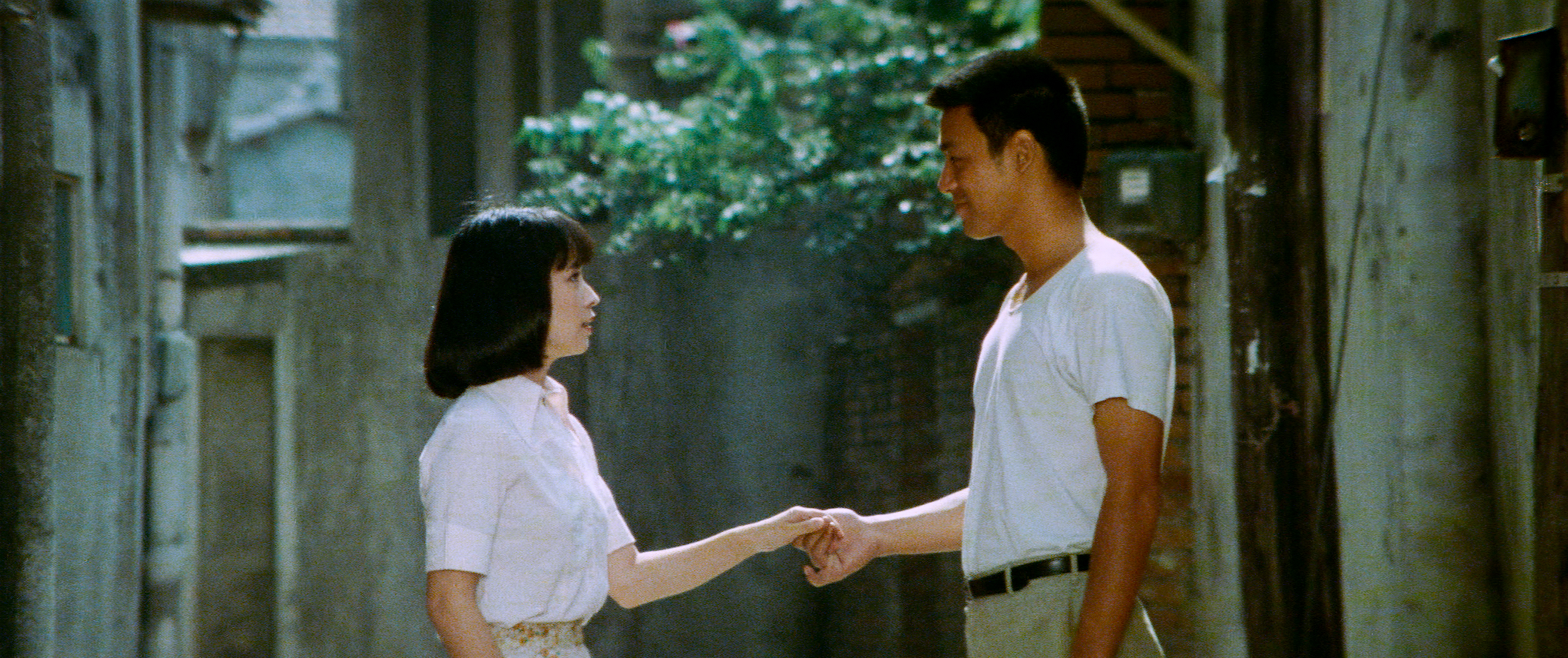 woman and man facing each other shaking hands