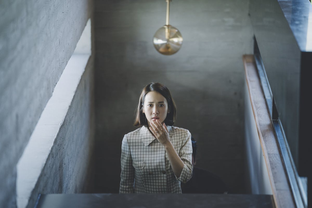 woman heading up the stairs inside a home