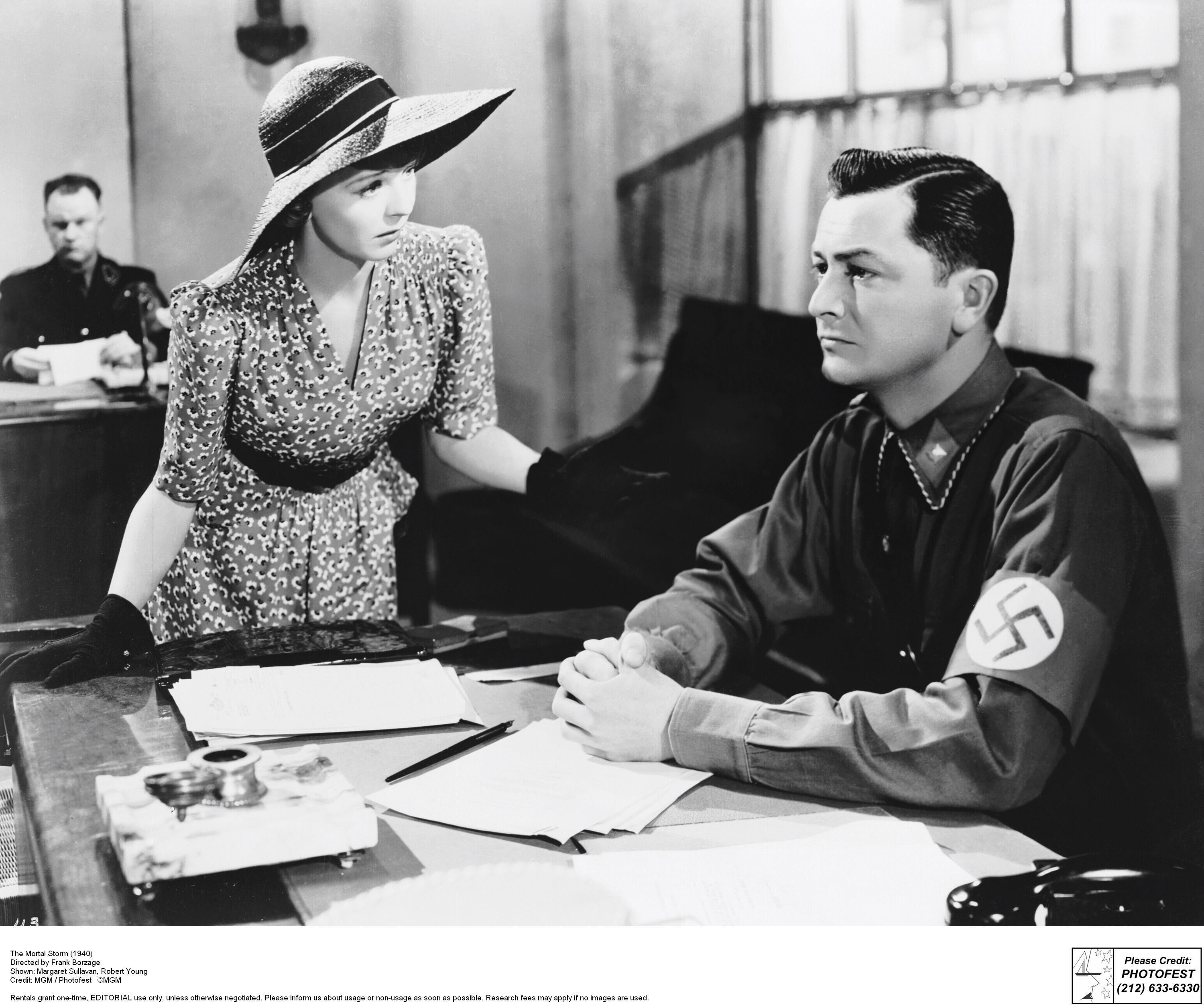 woman being ignored by a soldier with a swastika on his sleeve