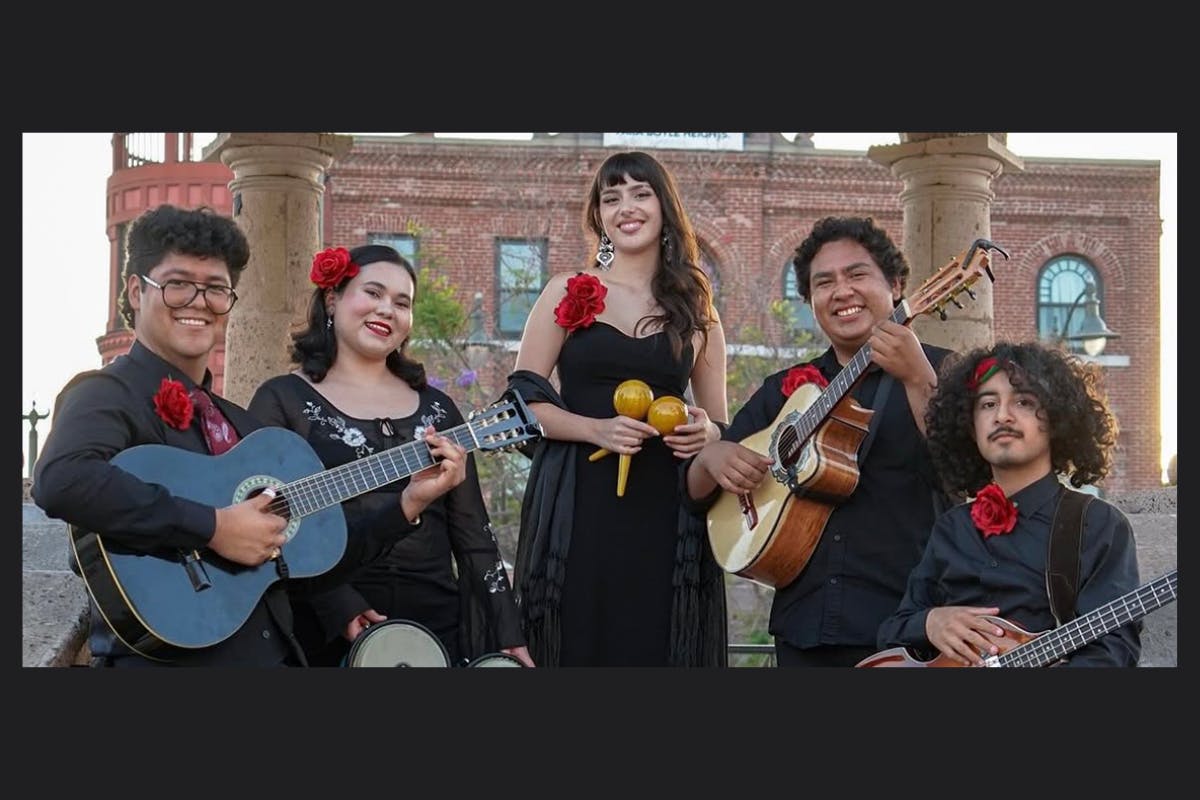 A group of performers pose with their instruments
