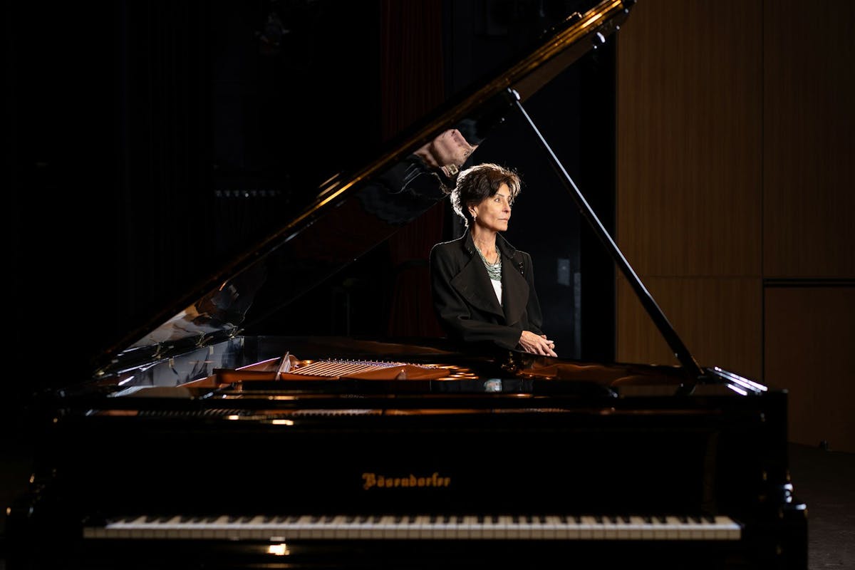 Tina Sinatra poses with her father's piano