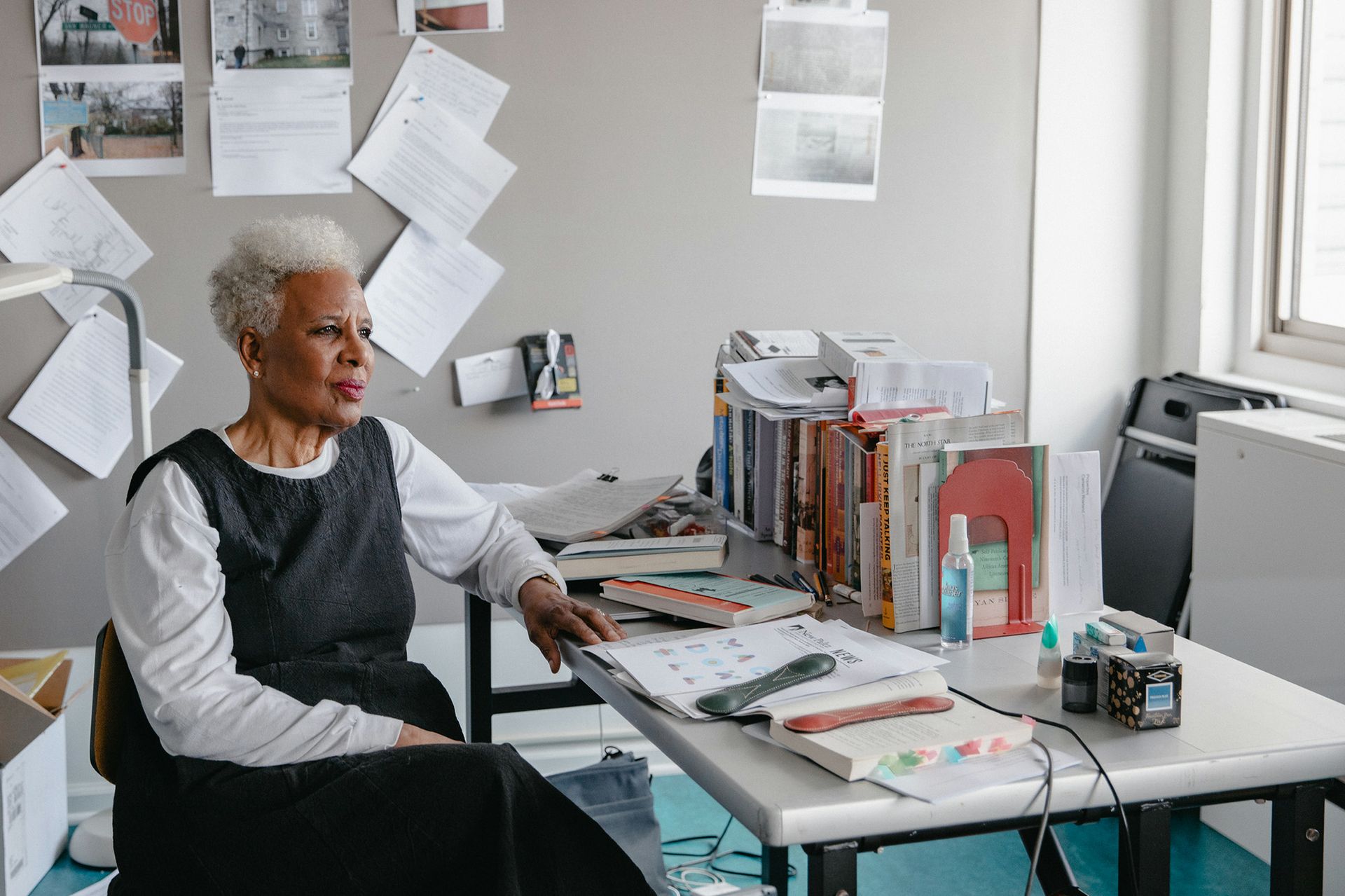 Artist Nell Irvin Painter sits at her work desk