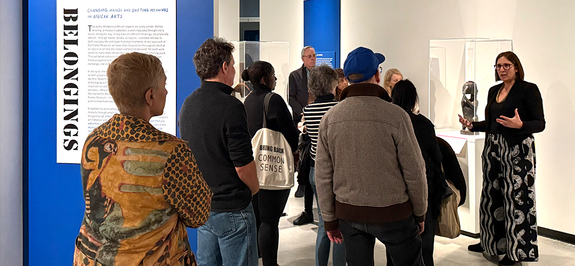 A curator talks to a group of visitors in the galleries of the fowler museum