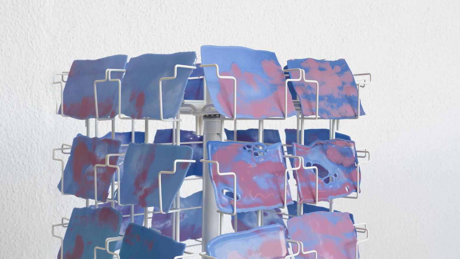 Photograph of work by artist Kelly Wall, color blocked glass "postcards"