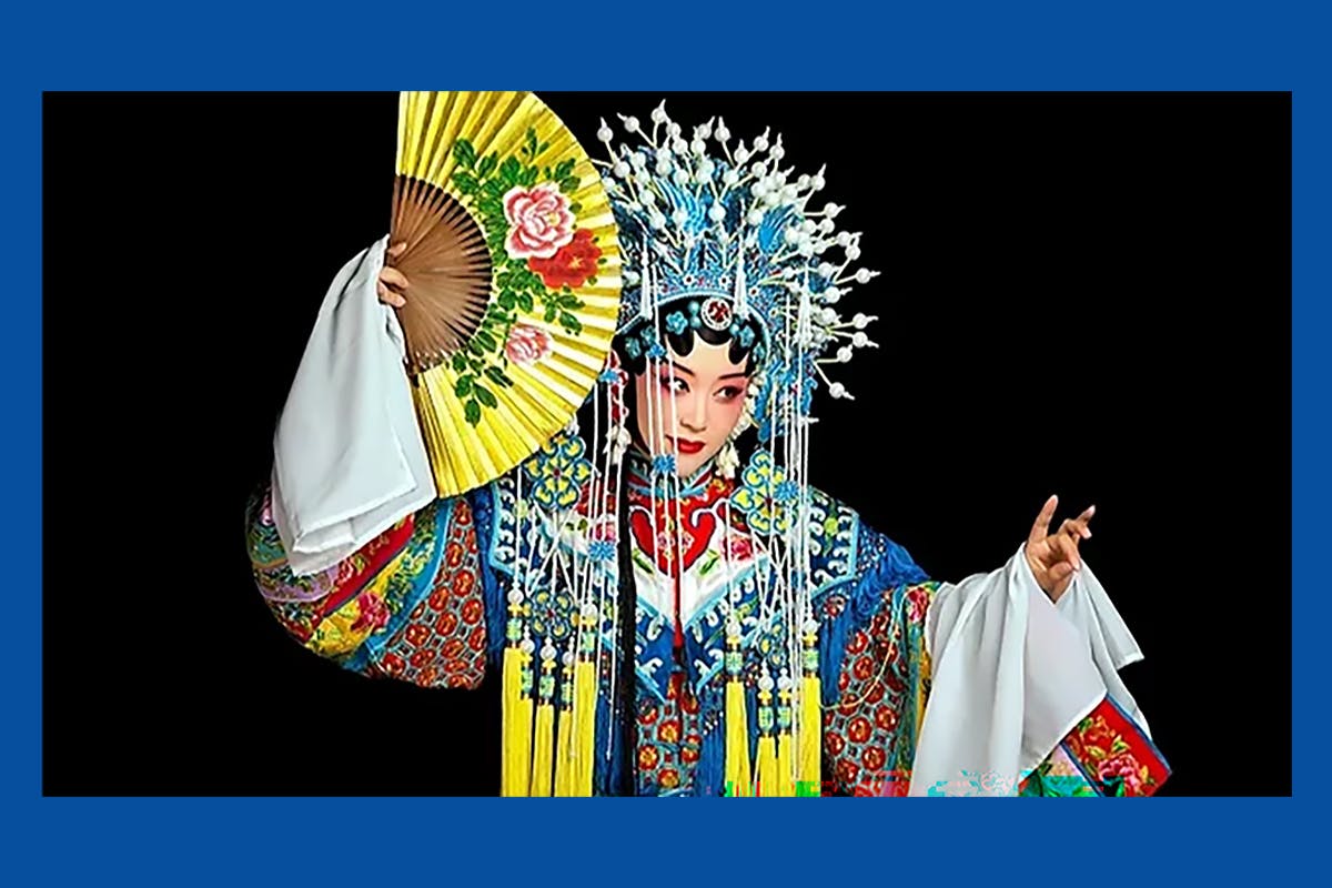 An opera singer performs in a very ornate Cantonese attire