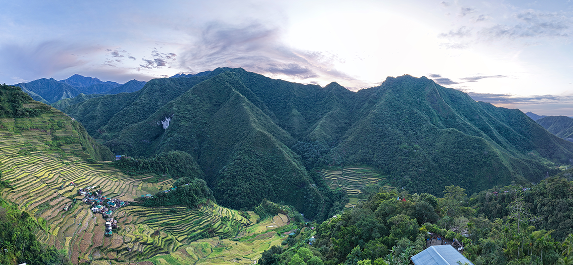A lush farming valley ringed by mountains