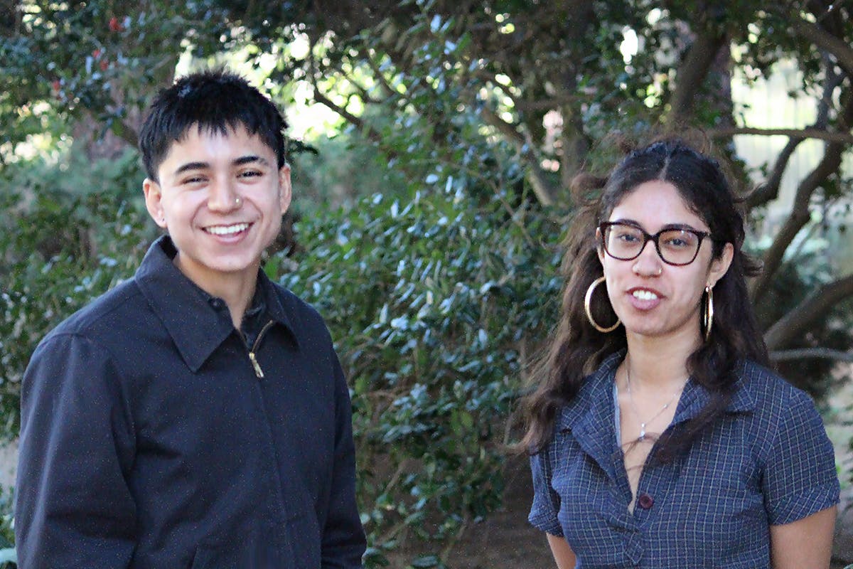 A pair of UCLA students pose together for a portrait outside.