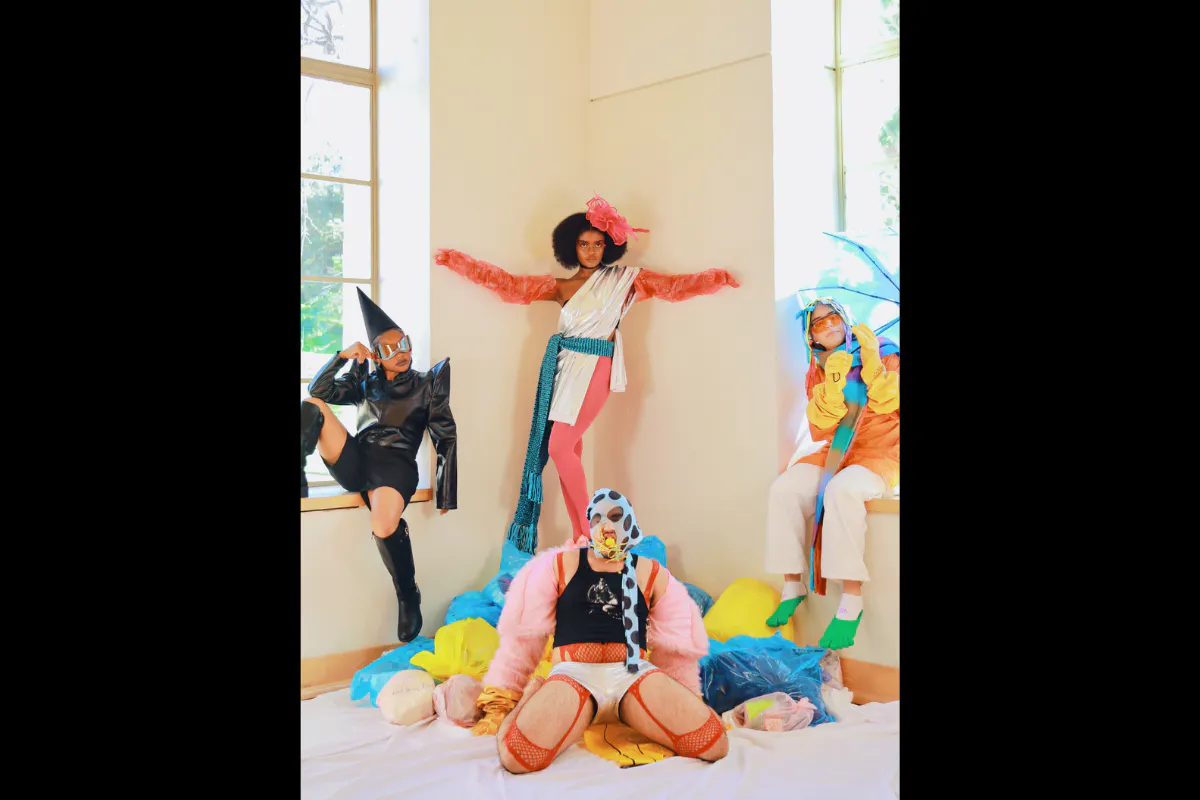 A group of dancers pose in colorful costumes.