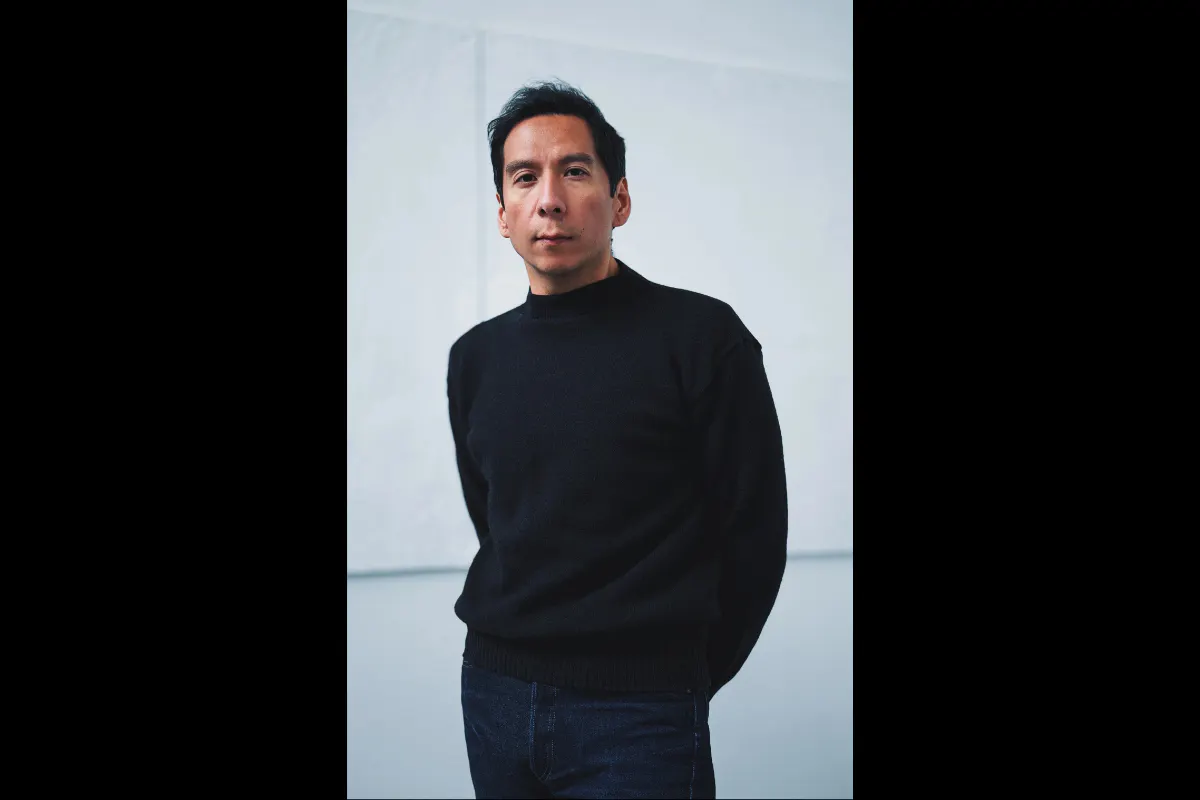 A portrait of Sky Hopina. He is looking at the camera