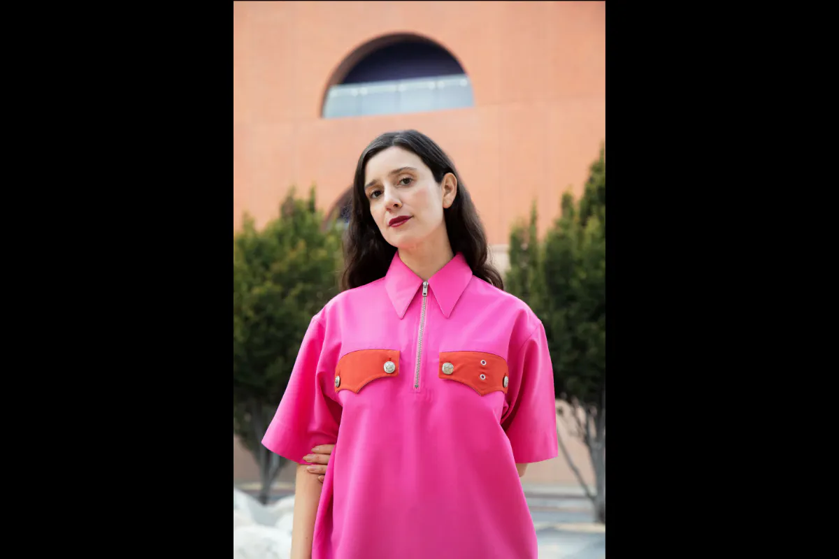 Portrait of Joanna. She is wearing a pink shirt and looking at the camera