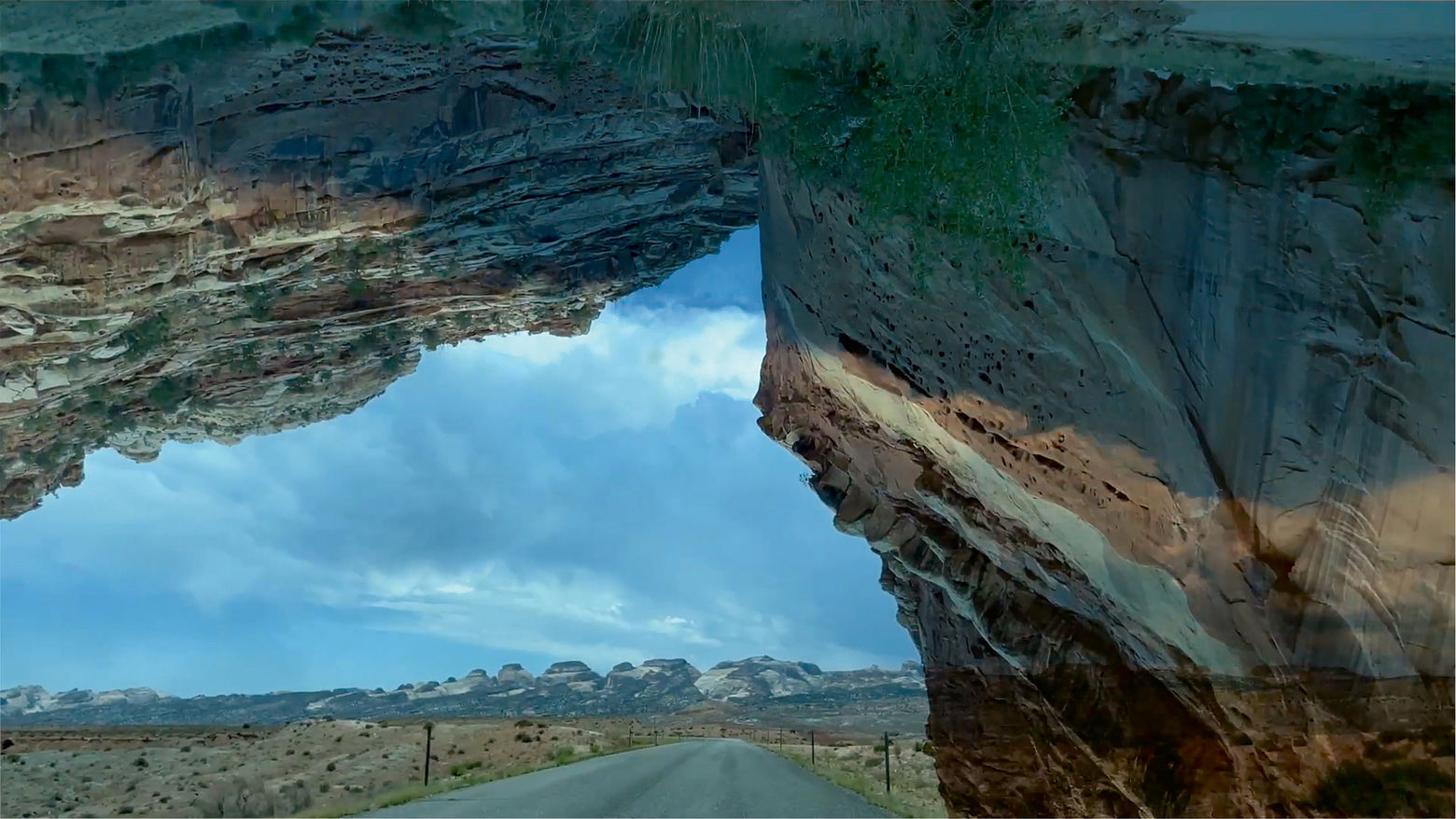 Esoteric image of a sky and road as seen through a rock crevice