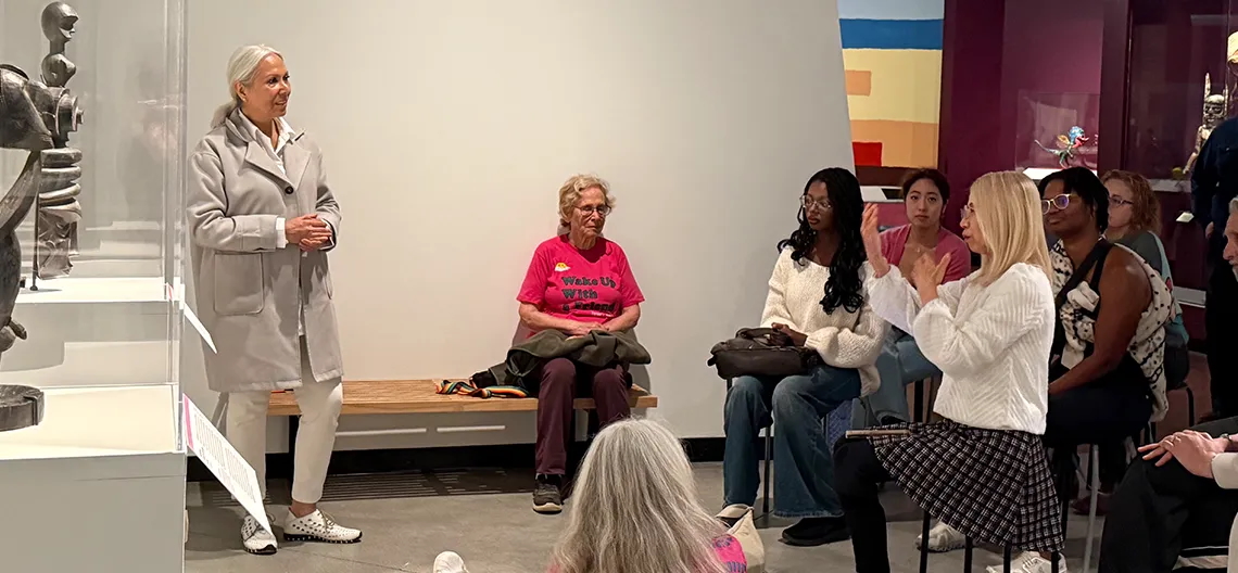 People sit in a Fowler Museum gallery for a talk