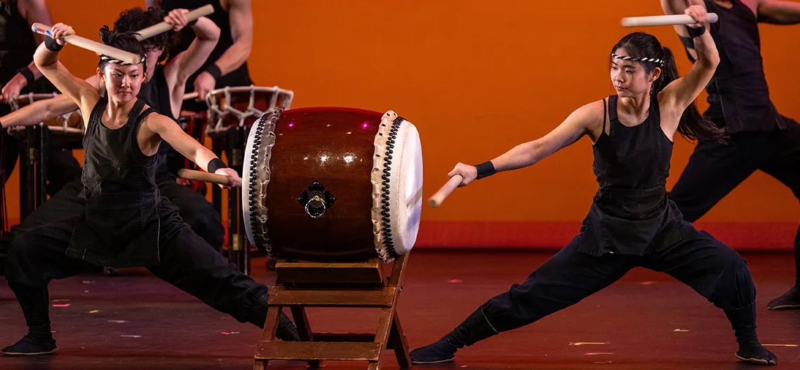 Two Taiko drummers perform