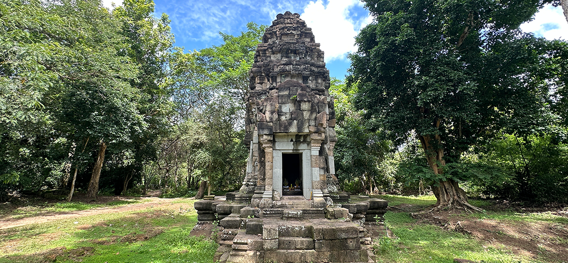 A stone structure in a green forest