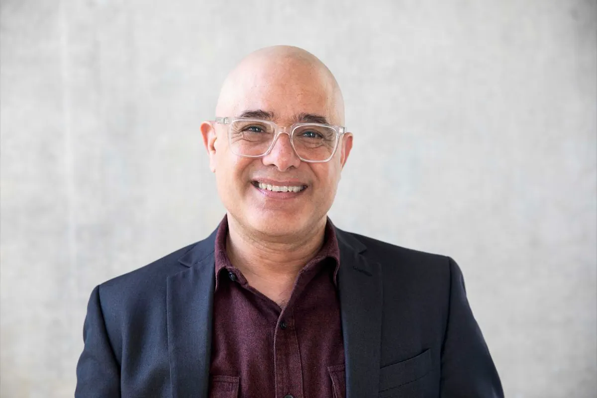 Portrait of Lionel Popkin. He is smiling at the camera