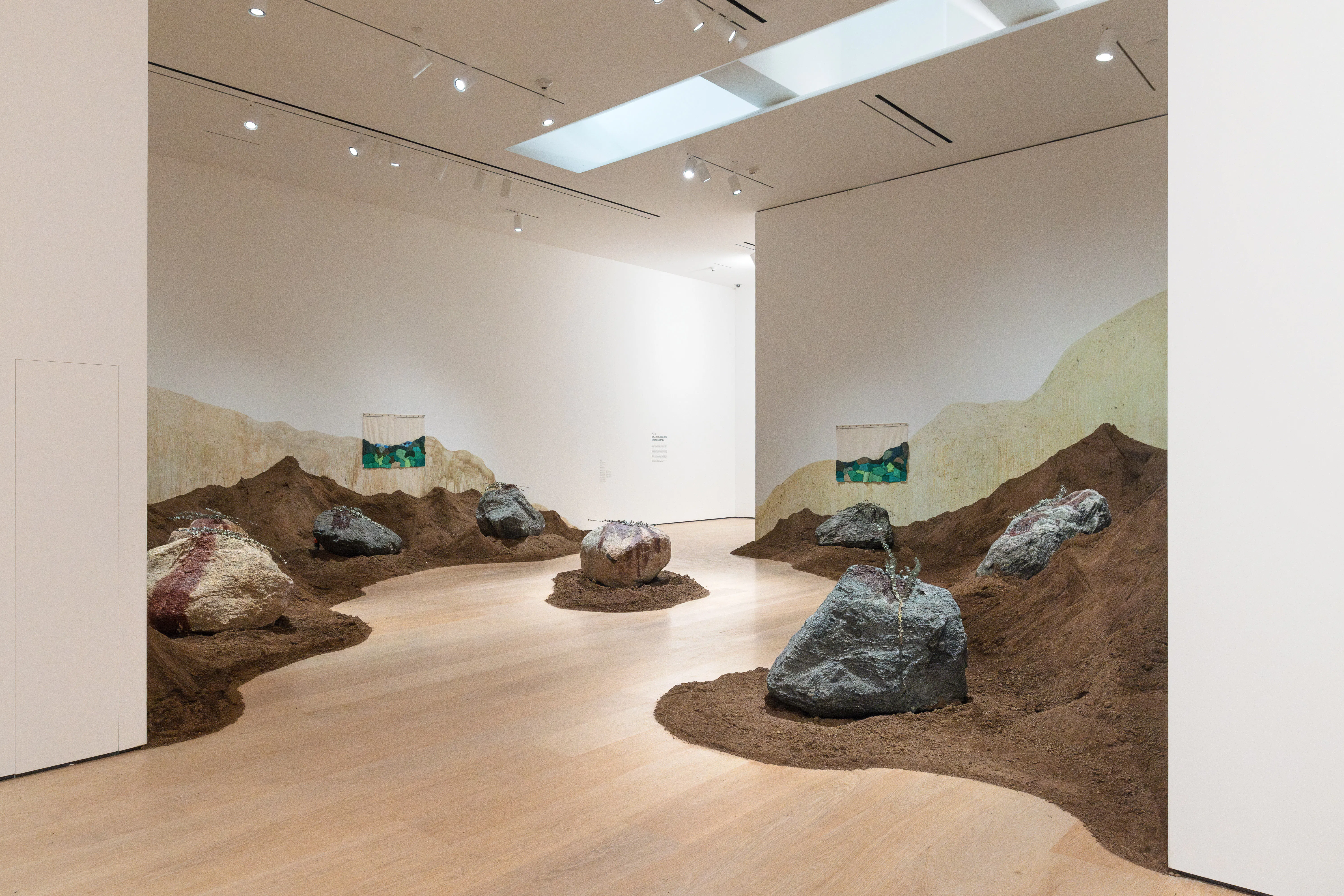 Unique installation at the Hammer museum made from soil, rocks and plants swooping across the space