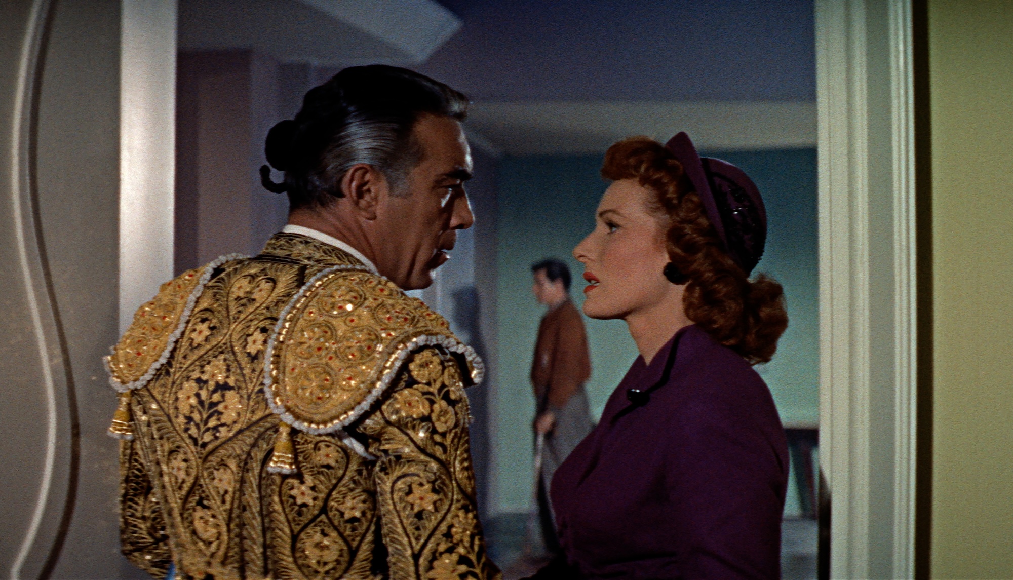 man in matador dress speaking with woman