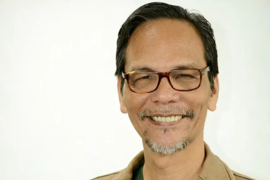 Headshot of  LaVerne David C. de la Peña smiling at the camera.