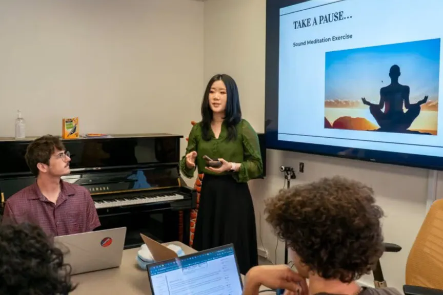 A student giving a presentation in front of her class.