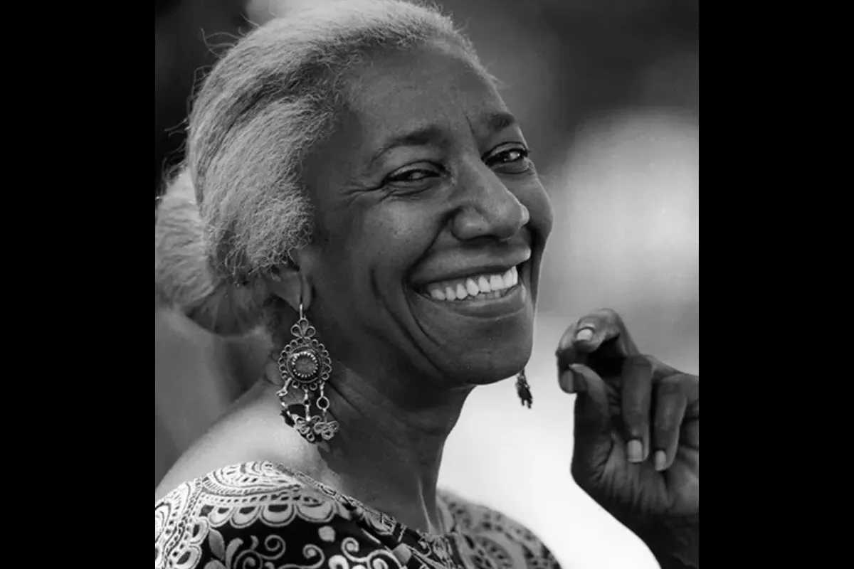 Black and white headshot of Edna Lewis. She is smiling at the camera.