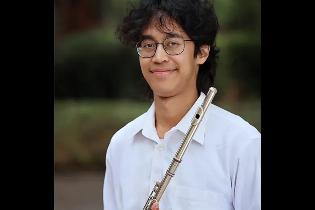 Portrait of performer Mickey Hashim, holding a flute