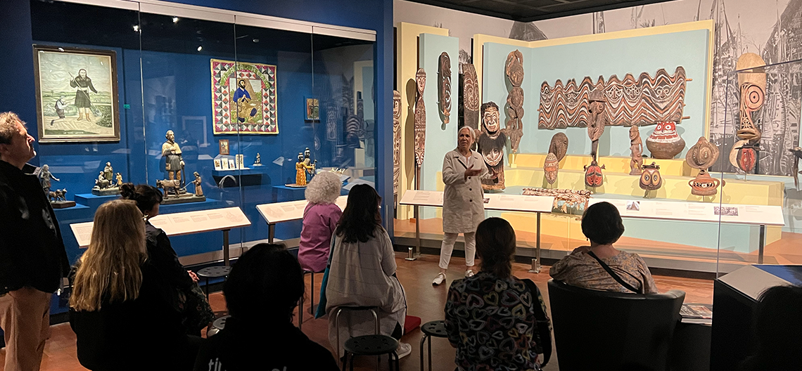 A curator talks to a group of people in the Fowler galleries