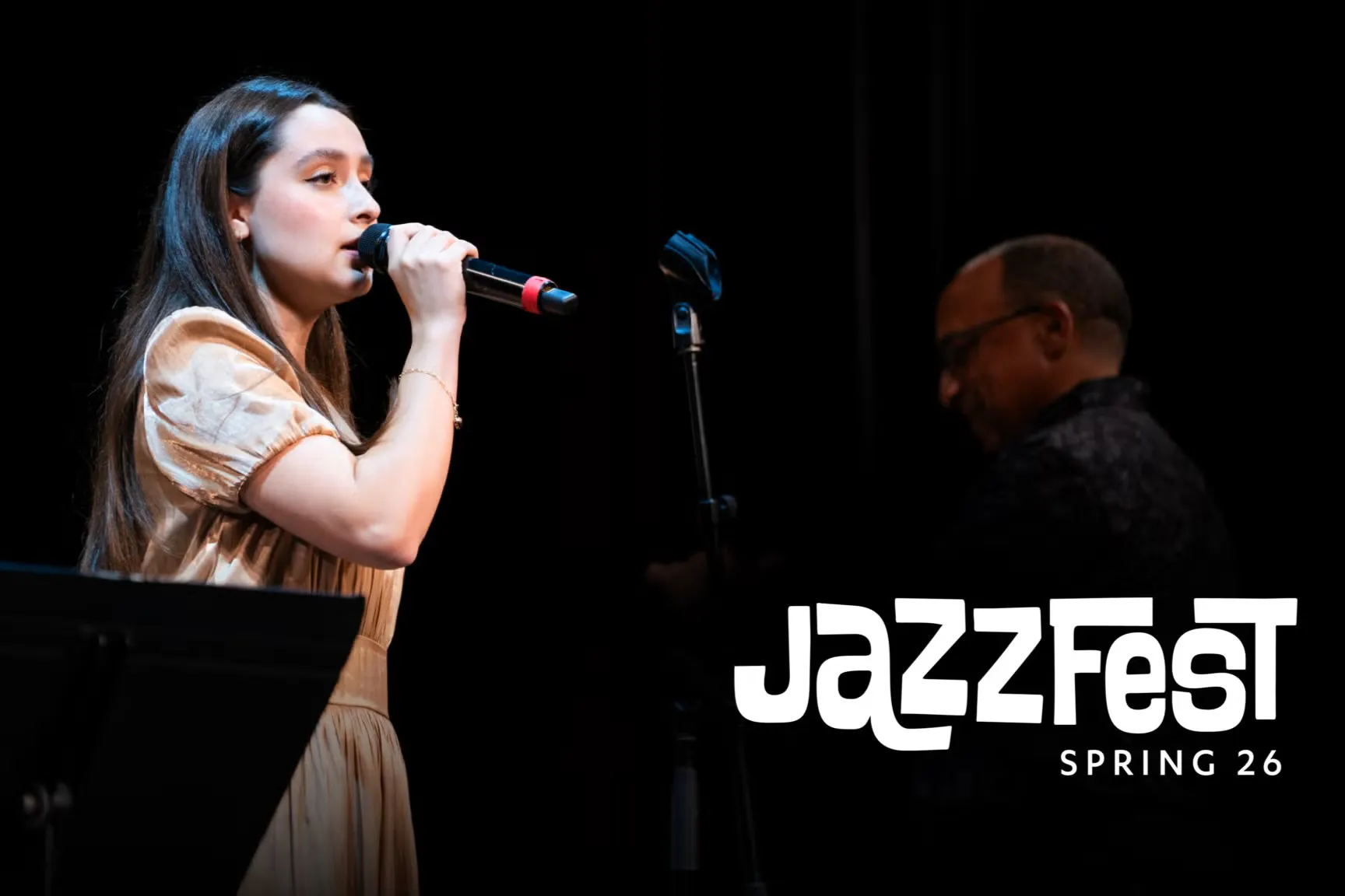 Singer on stage with words "JazzFest Spring 26". 