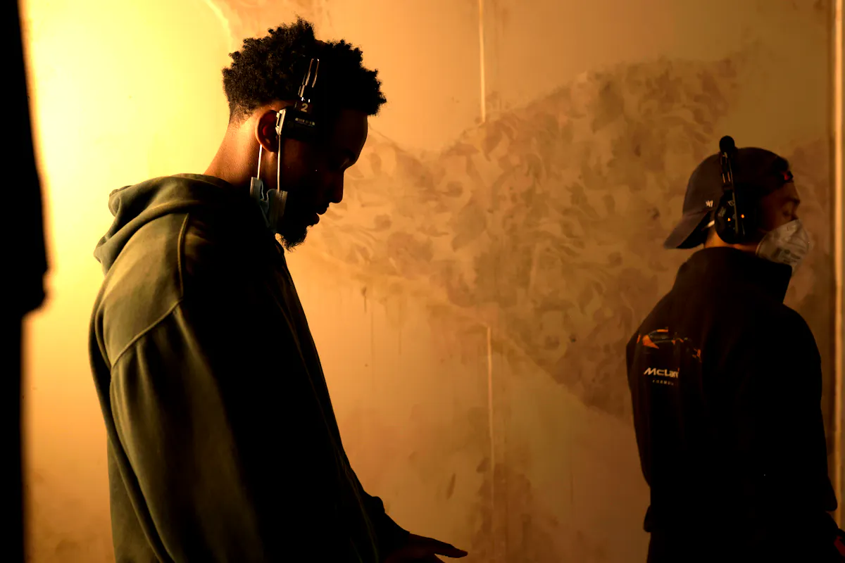 A director behind the camera of an atmospheric scene with sepia-tinted lighting