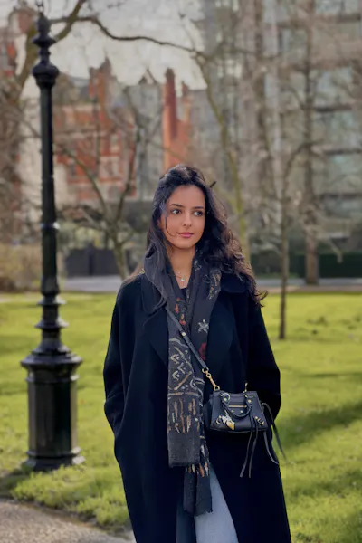 Portrait of Dina Alkhateeb. She is wearing a winter coat