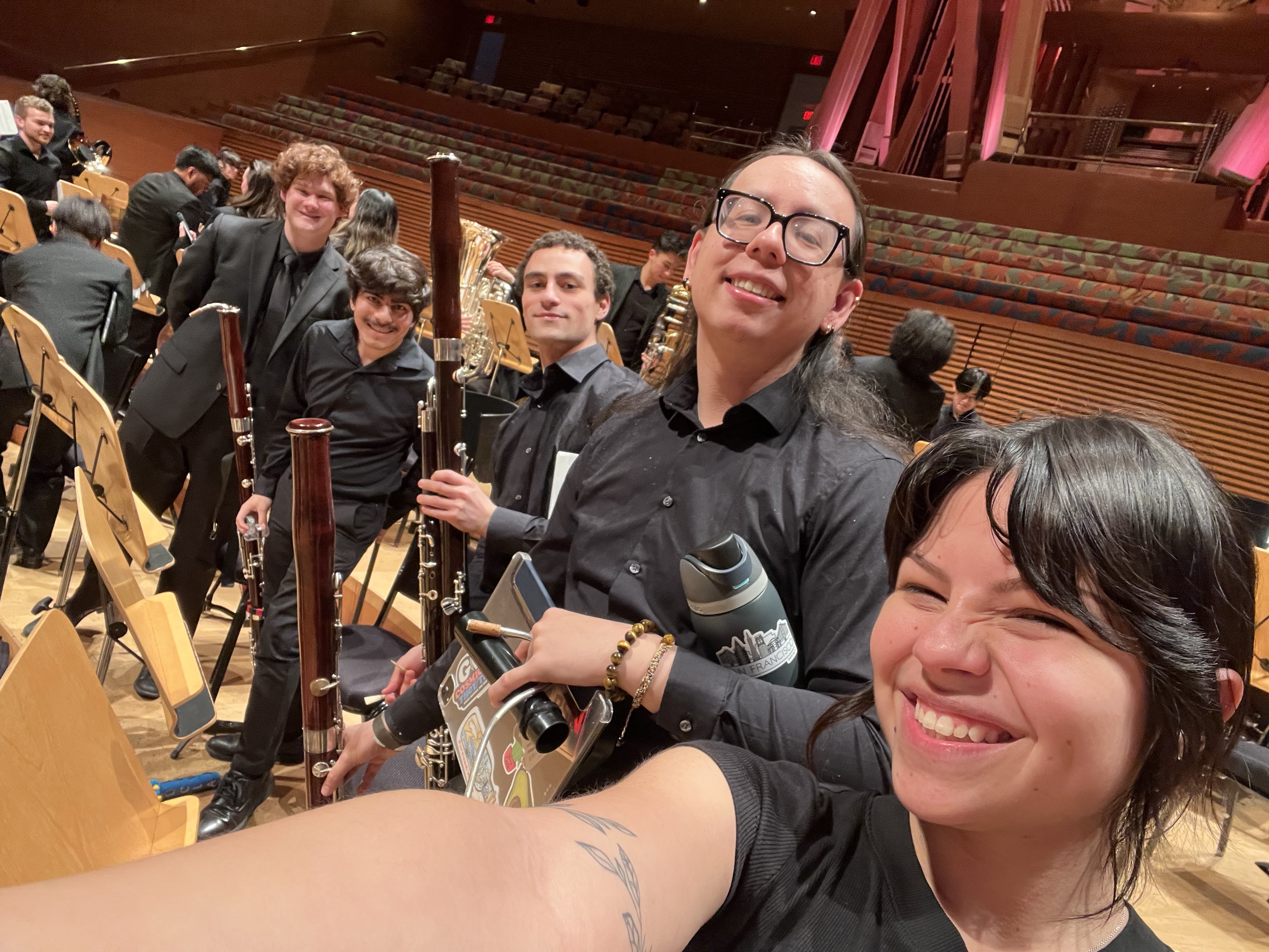A group of bassoon players pose together after a performance