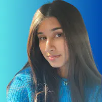 Portrait of Naisha Argawal. She is wearing a blue sweater