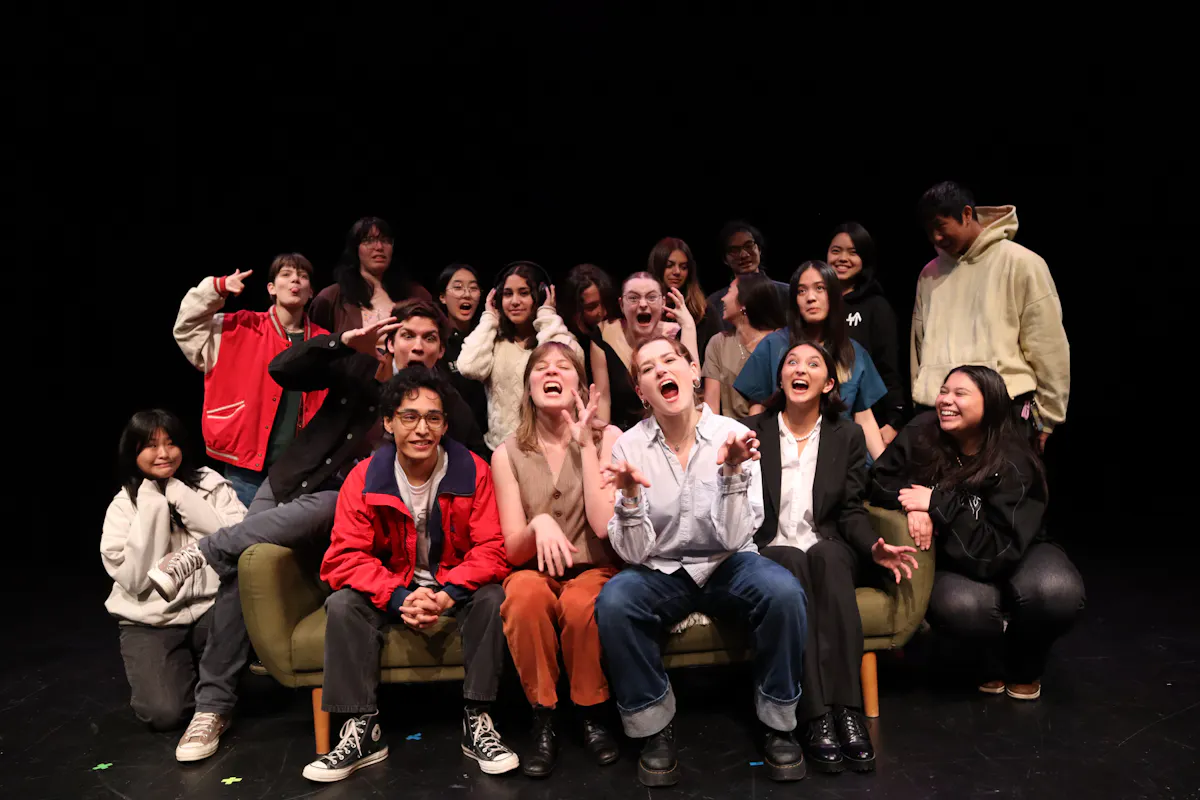 A group of performers pose together after a show