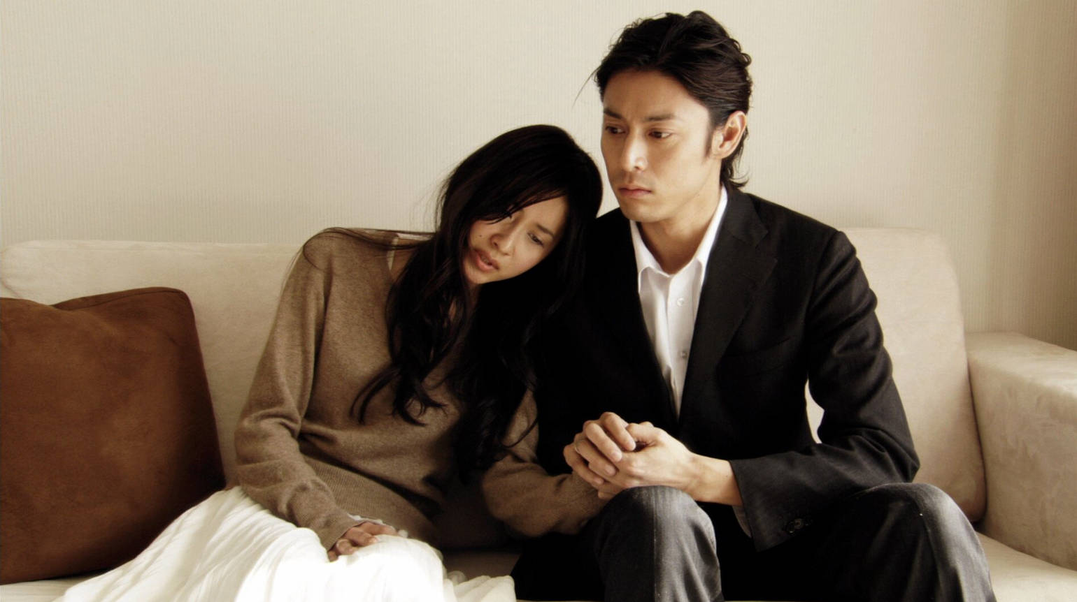 woman leaning into a man as they sit on a couch