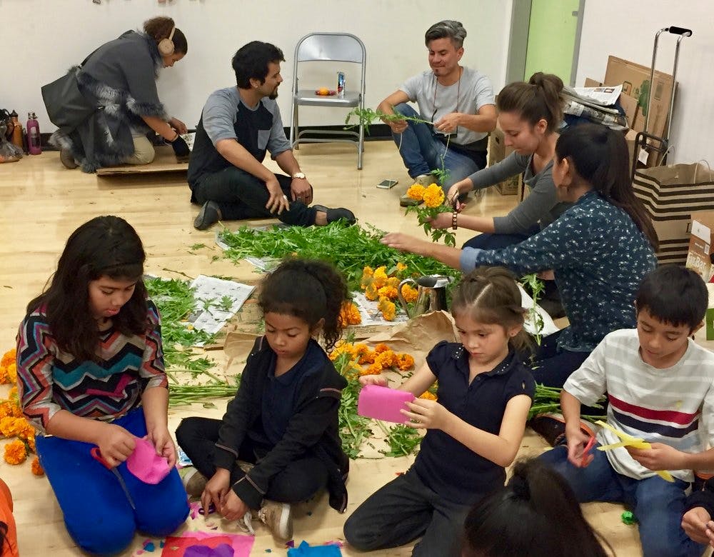 A group of children creating flower decorations.