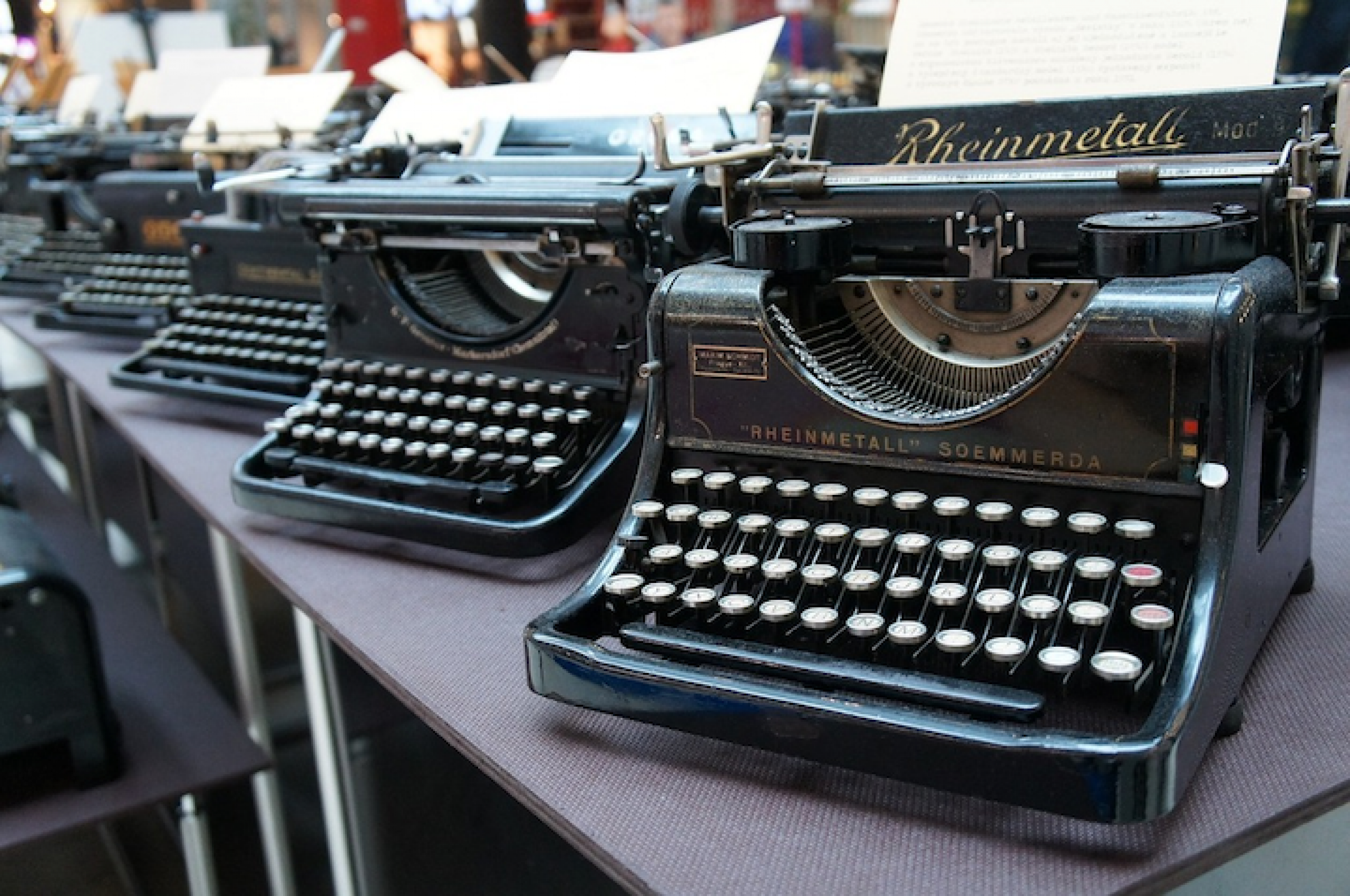 Several vintage typewriters on a table