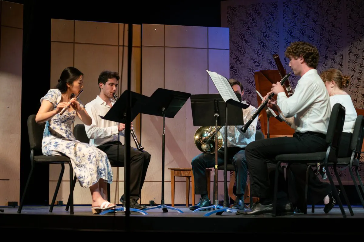 A small group of woodwind performers onstage in UCLA's Lani Hall