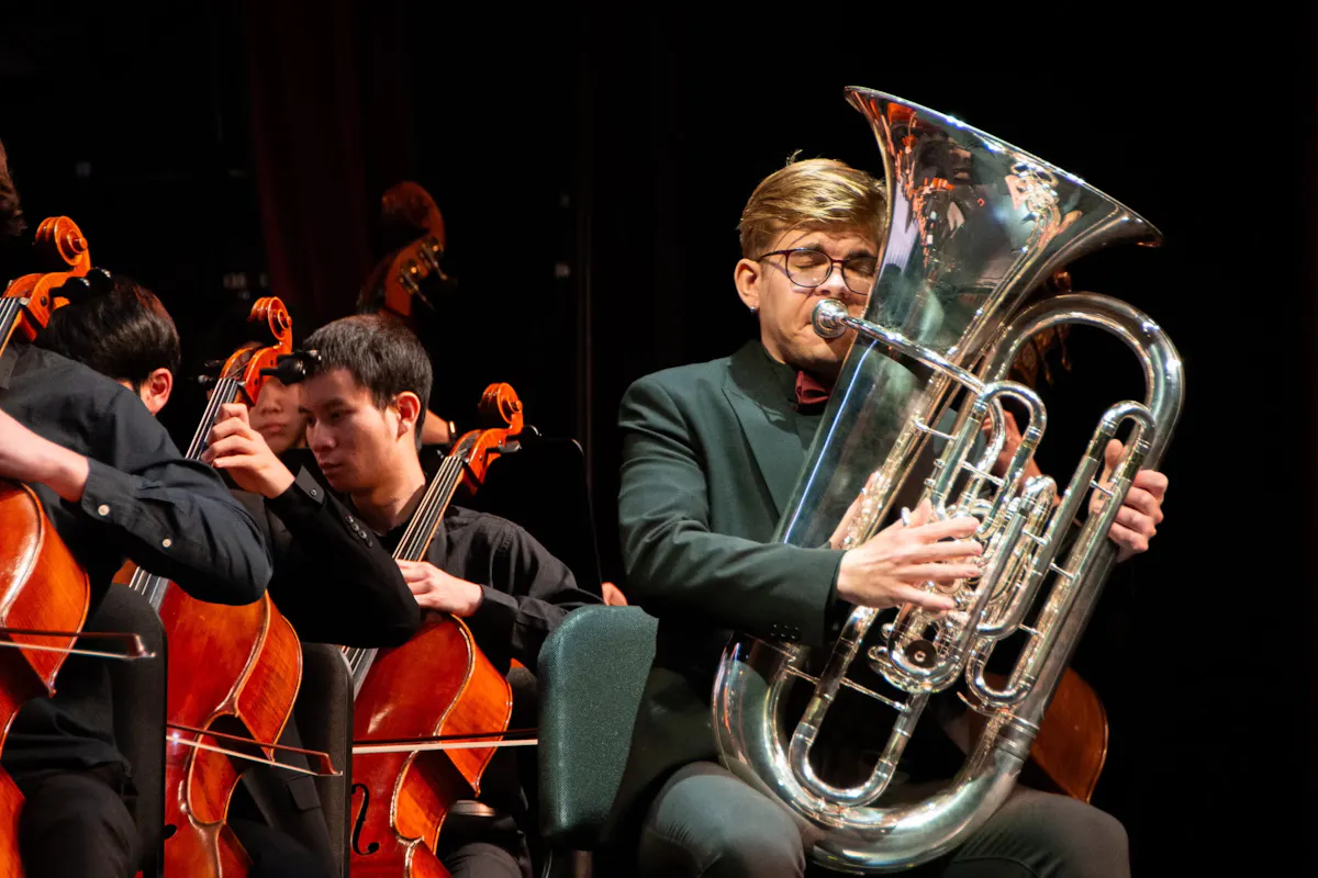 Tuba player and cellists performing