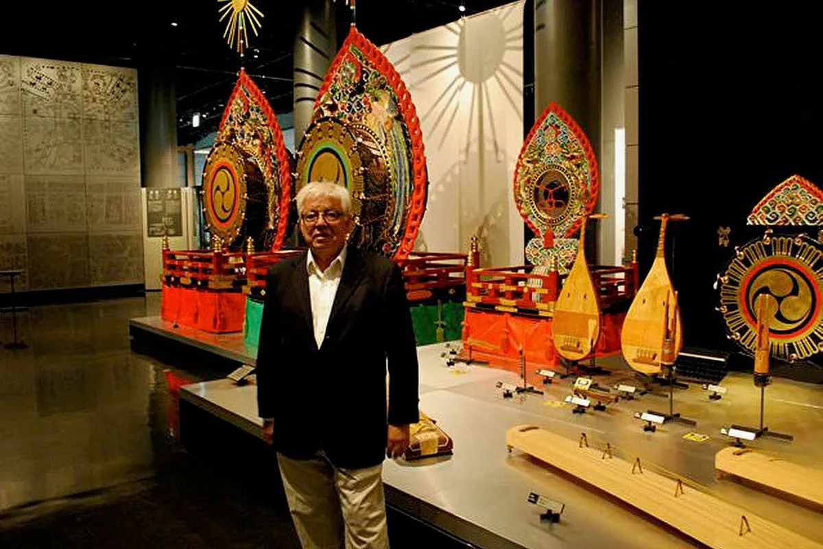 A man stands among a vibrant display of objects