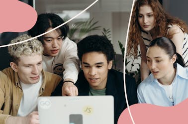 A group of people looking at a laptop screen