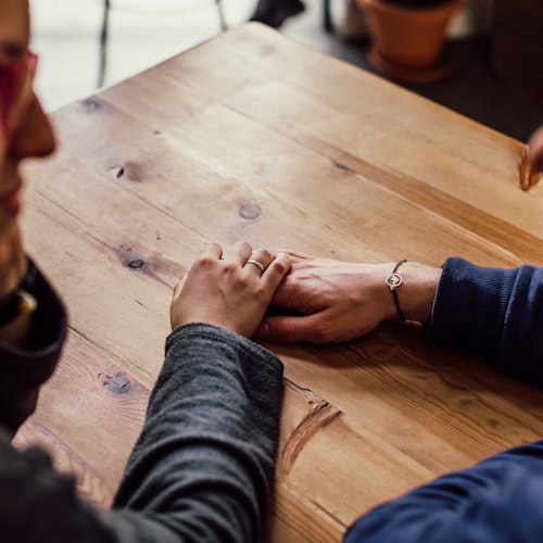 Two people having a serious conversation and providing support to one another