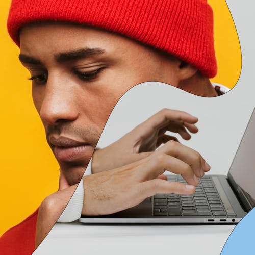 Man in a red beanie typing on a laptop, representing a modern learner