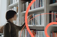 Woman choosing books in a library