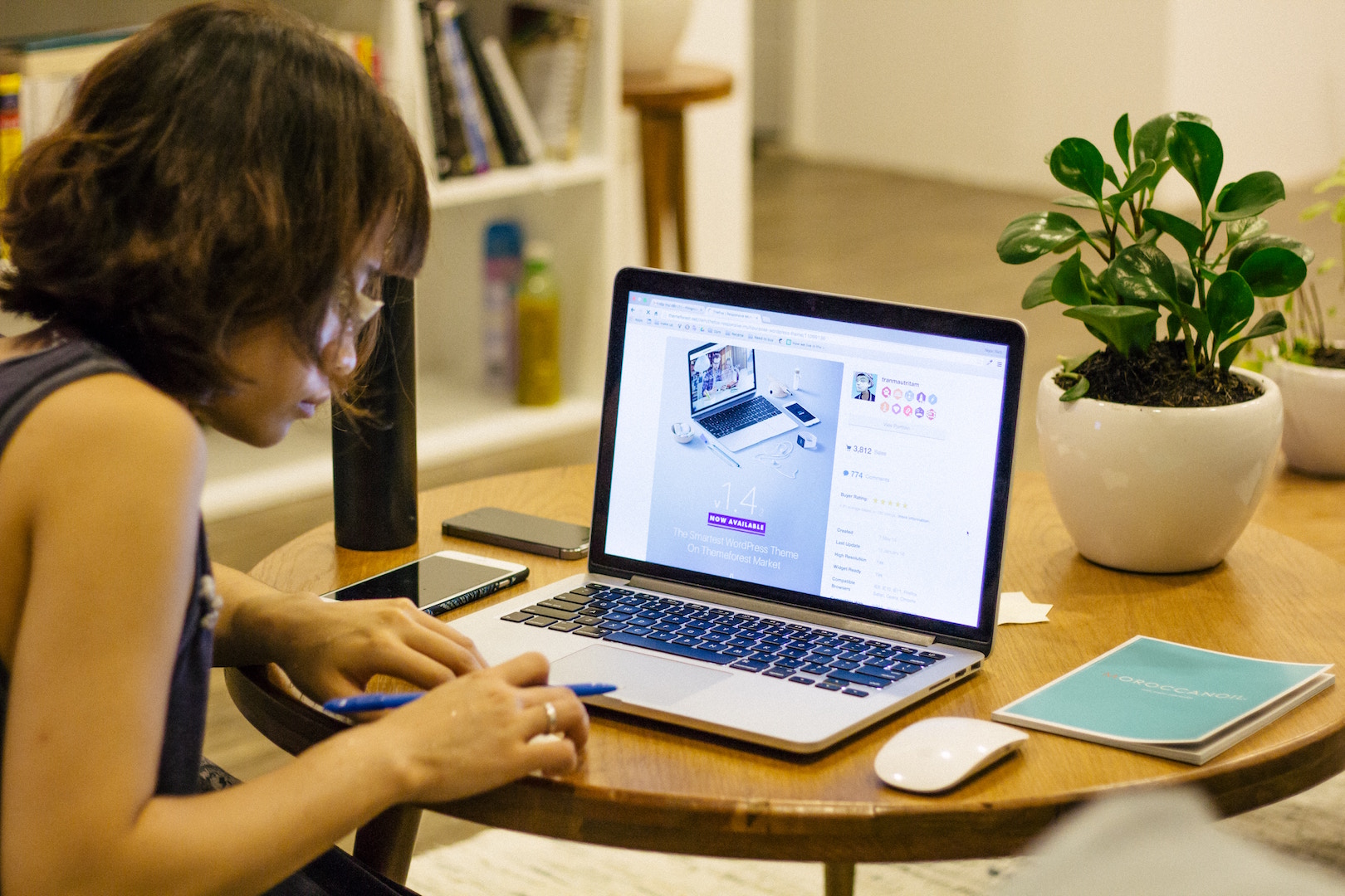 Woman sitting at a table working on a laptop